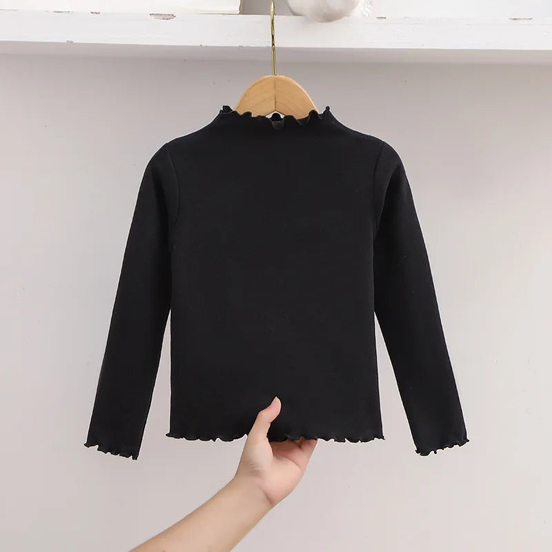 Ropa para niños, nueva camiseta básica para niñas de otoño e invierno, camiseta de manga larga de color liso con borde de hongo negro a la moda para niños.