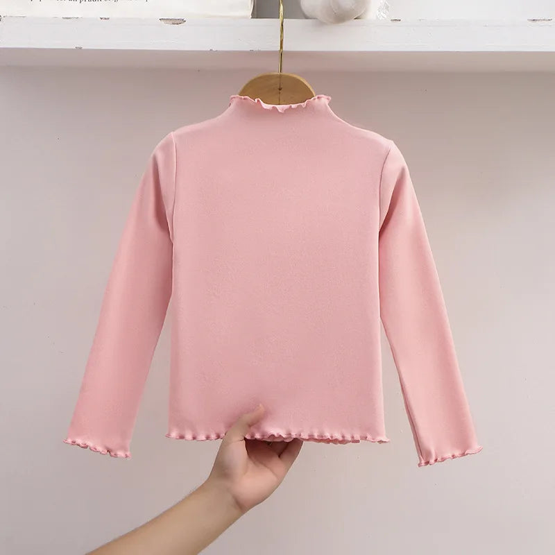 Ropa para niños, nueva camiseta básica para niñas de otoño e invierno, camiseta de manga larga de color liso con borde de hongo negro a la moda para niños.
