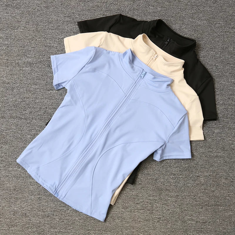 Camisetas de entrenamiento adelgazantes de cintura de verano de alta calidad para mujer, de secado rápido, con cuello alto ajustado y cremallera completa, camisetas de yoga de manga corta.