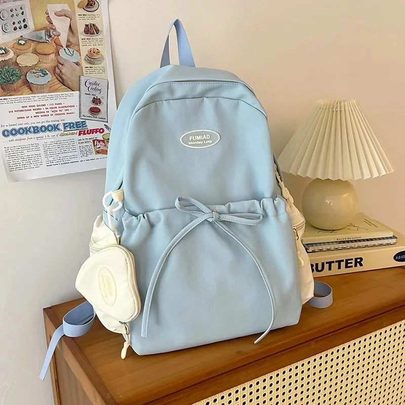 Bonita mochila escolar de nailon con doble hombro para niña, capacidad de 20 a 35 litros, forro de polietileno, correa curva, diseño de color liso.