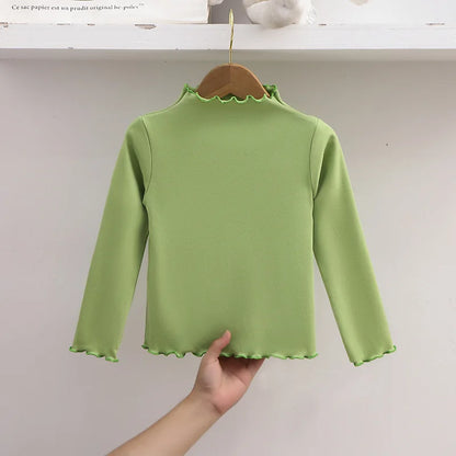 Ropa para niños, nueva camiseta básica para niñas de otoño e invierno, camiseta de manga larga de color liso con borde de hongo negro a la moda para niños.