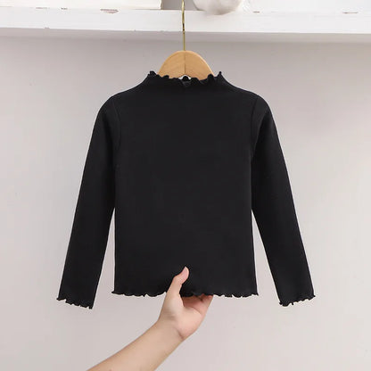 Ropa para niños, nueva camiseta básica para niñas de otoño e invierno, camiseta de manga larga de color liso con borde de hongo negro a la moda para niños.