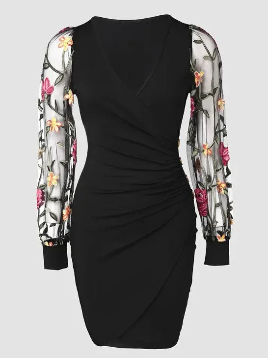 Elegante vestido midi ajustado con bordado floral, mangas de malla transparente y escote en V. Detalle de botones con estilo. Largo hasta la rodilla.