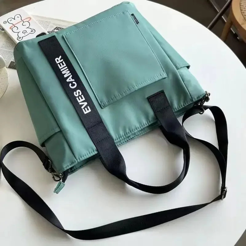 Nuevo bolso de hombro informal de gran capacidad, de nailon, impermeable, de lona, sencillo y moderno, para colegiala.