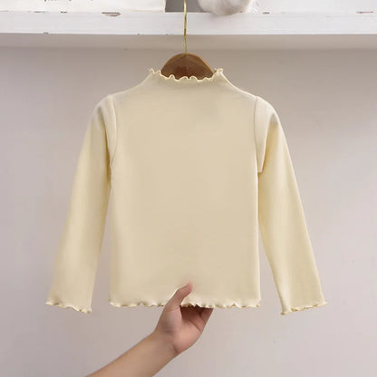 Ropa para niños, nueva camiseta básica para niñas de otoño e invierno, camiseta de manga larga de color liso con borde de hongo negro a la moda para niños.