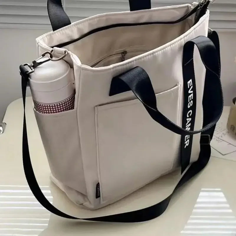 Nuevo bolso de hombro informal de gran capacidad, de nailon, impermeable, de lona, sencillo y moderno, para colegiala.