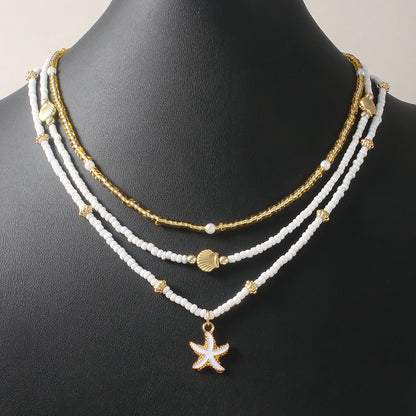 Gargantilla bohemia hecha a mano con cuentas apiladas, delicado collar con colgante de concha de estrella de mar, joyería para mujer para fiestas de playa y vacaciones de verano