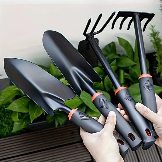 Un juego de cuatro herramientas de jardinería para exteriores que incluye una pala pequeña para plantar flores, un rastrillo de cinco puntas y un rastrillo de dos cabezas.